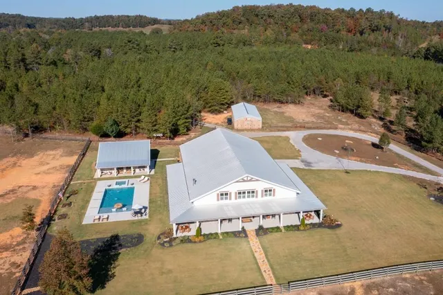 an aerial view of a house with a yard