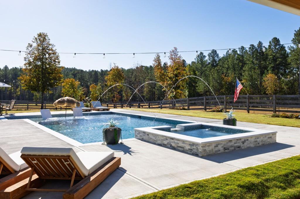 125 Perry Road Rydal, GA 30171 - Photo 73 of 139 a view of swimming pool with seating area and trees in the background