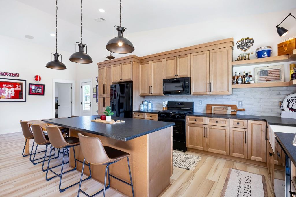 125 Perry Road Rydal, GA 30171 - Photo 90 of 139 a kitchen with stainless steel appliances granite countertop a sink a stove a dining table and chairs