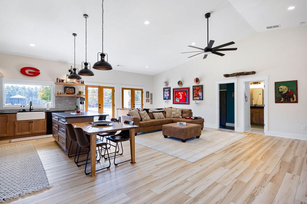 125 Perry Road Rydal, GA 30171 - Photo 92 of 139 a living room with furniture kitchen view and a wooden floor
