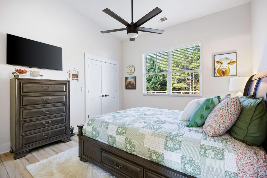125 Perry Road Rydal, GA 30171 - Photo 97 of 139 a bedroom with a bed and a flat screen tv