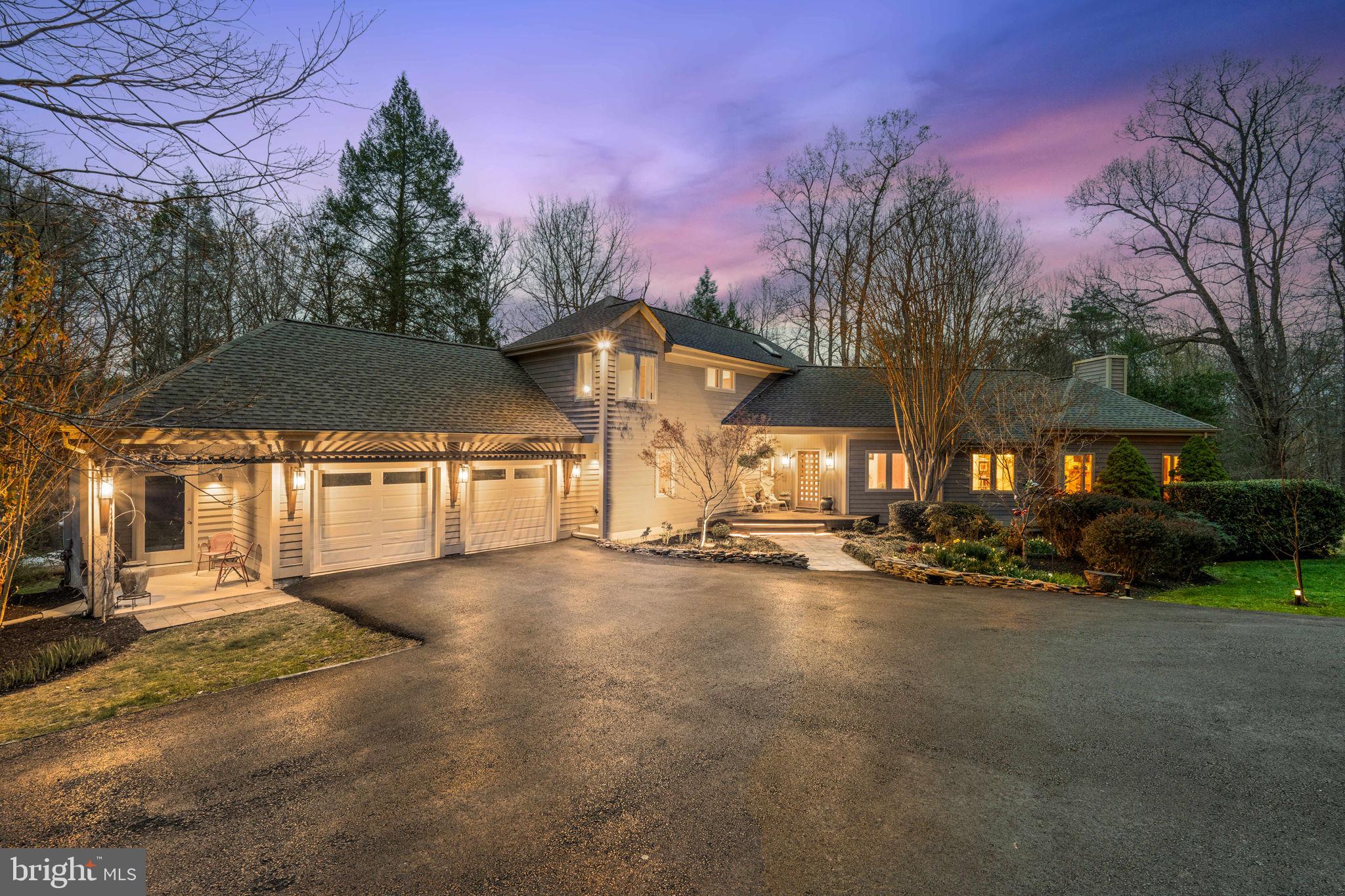 a view of a street with a house in the background