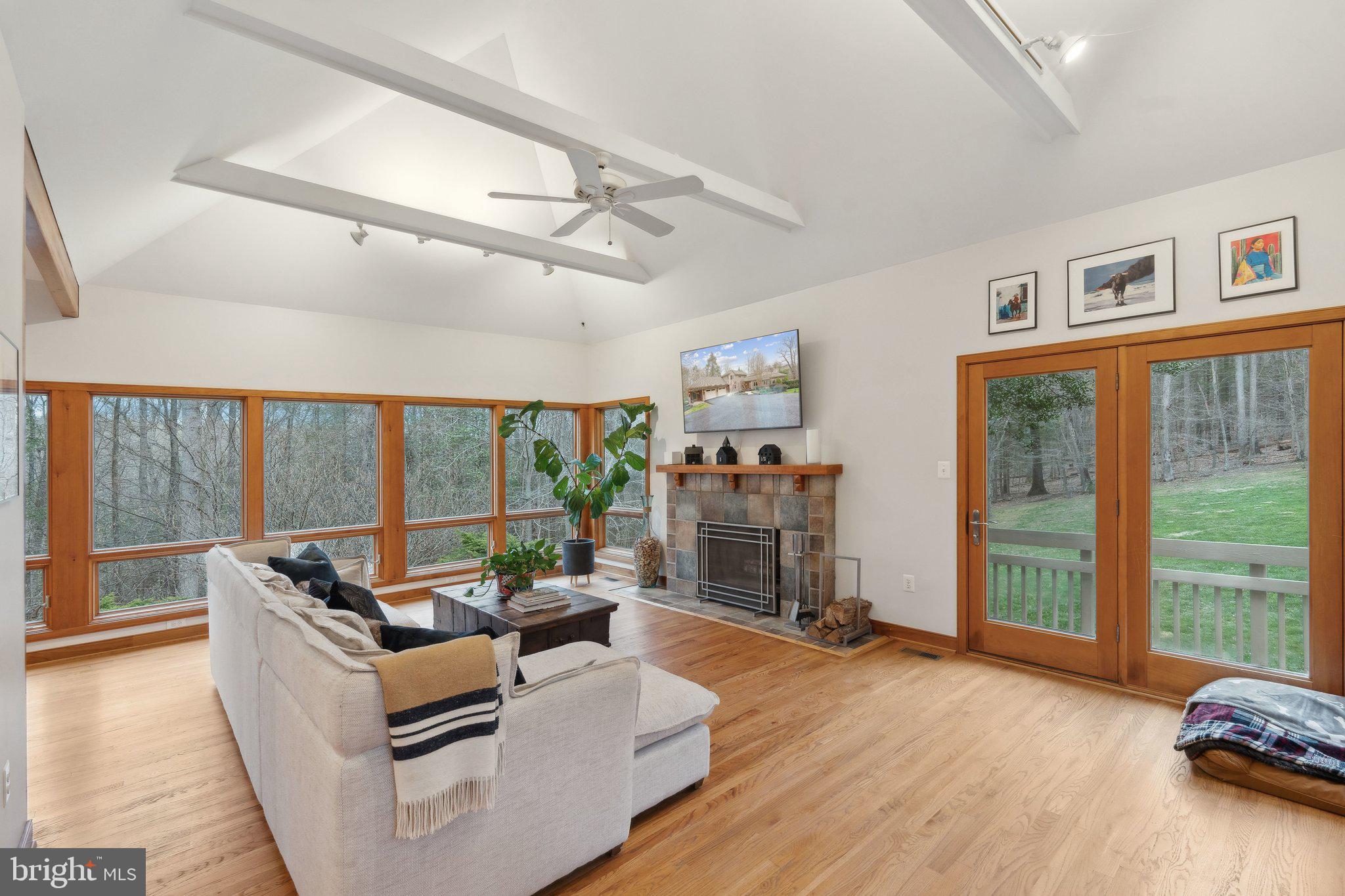 7514 A Evans Ford Road Clifton, VA 20124 - Photo 11 of 50 a living room with fireplace furniture and a floor to ceiling window