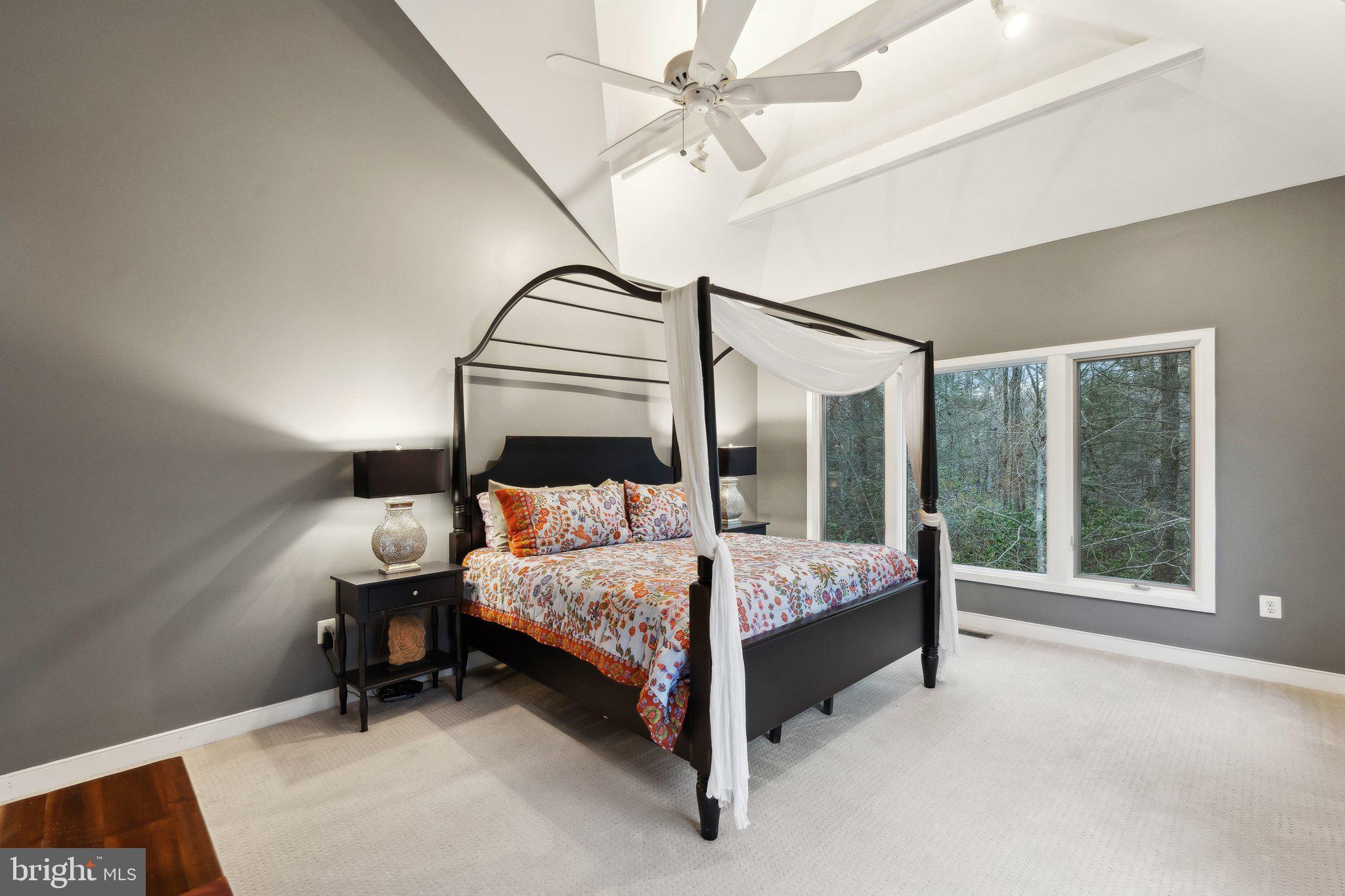 7514 A Evans Ford Road Clifton, VA 20124 - Photo 24 of 50 a bedroom with a bed lamp and a large window