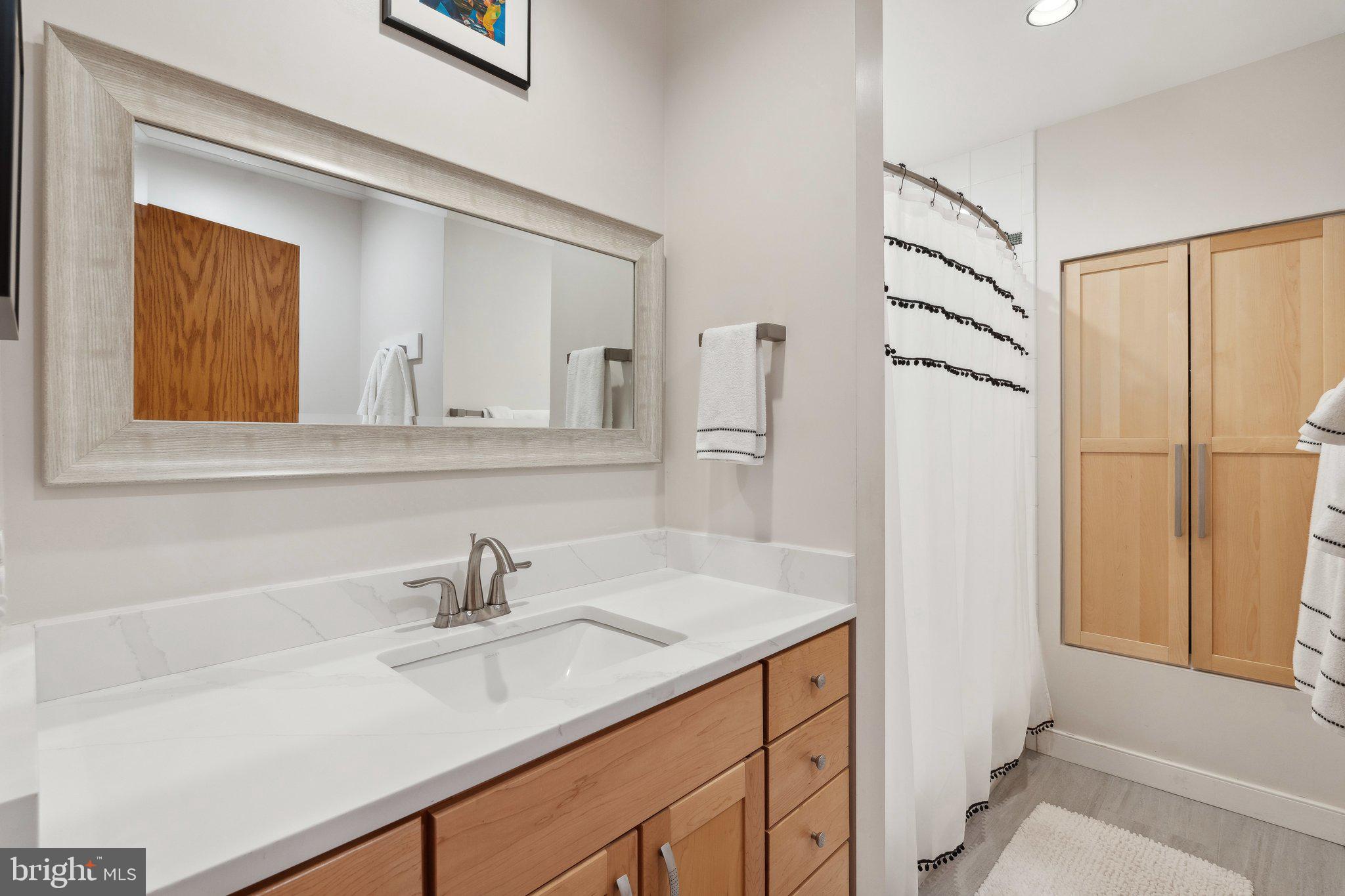 7514 A Evans Ford Road Clifton, VA 20124 - Photo 30 of 50 a bathroom with a sink and a mirror