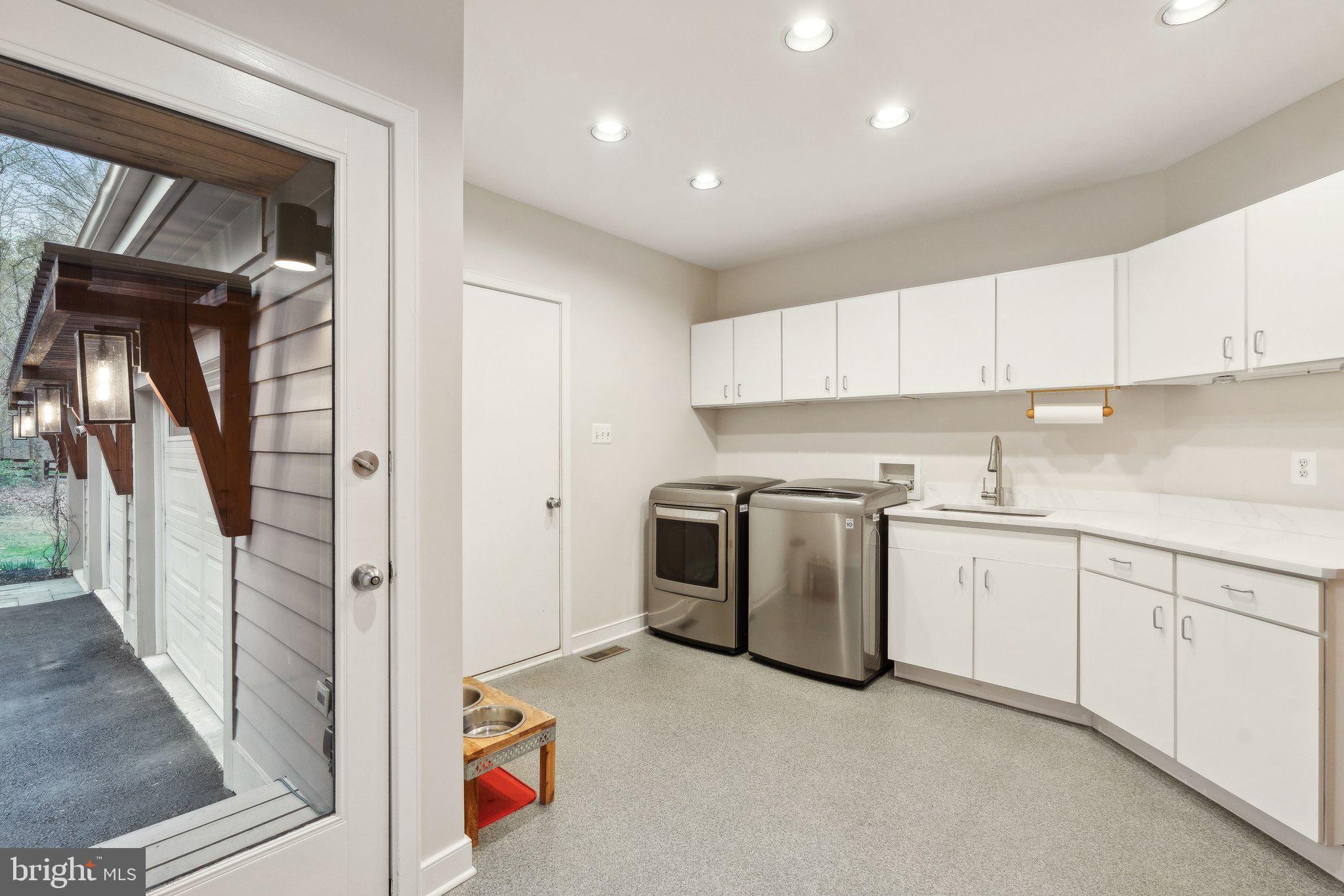 7514 A Evans Ford Road Clifton, VA 20124 - Photo 31 of 50 a kitchen with granite countertop a white stove and white cabinets