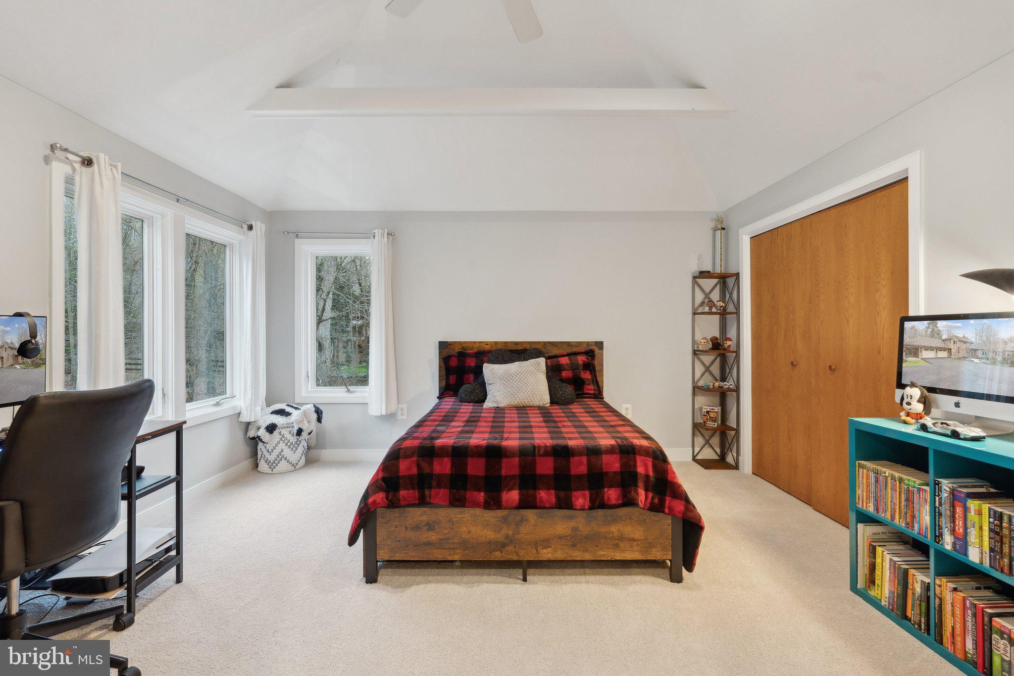 7514 A Evans Ford Road Clifton, VA 20124 - Photo 32 of 50 a bedroom with a bed a large window and book shelf
