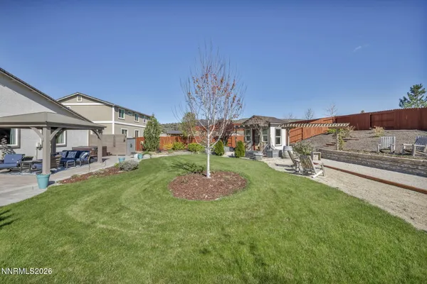 an aerial view of a house with a swimming pool outdoor seating and yard