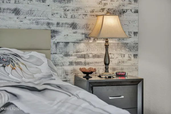 a bedroom with a bed and a painting on the wall