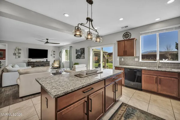 a kitchen with kitchen island granite countertop wooden cabinets and granite counter tops