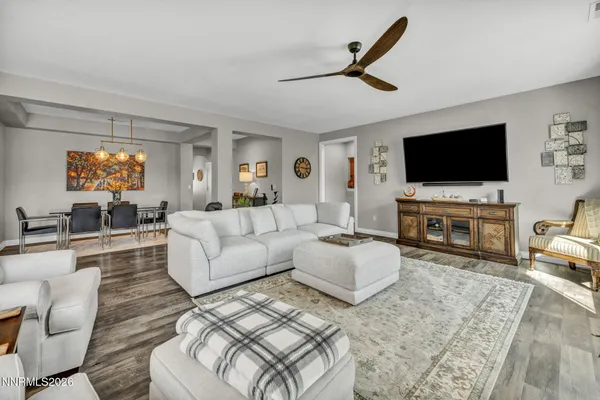 a living room with furniture a flat screen tv and a fireplace