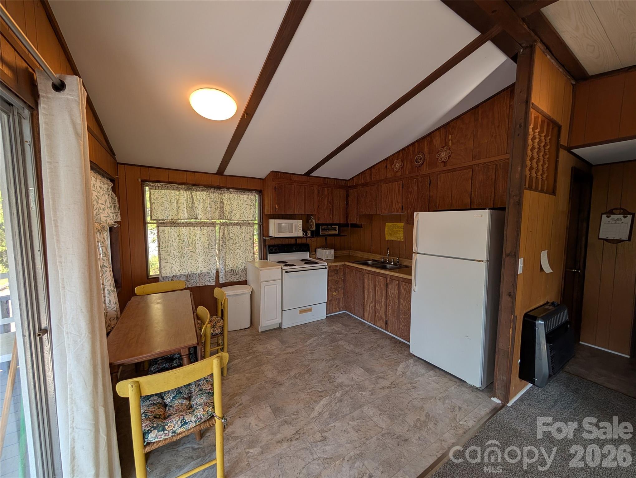 260 Oak Ridge Road Hendersonville, NC 28792 - Photo 12 of 24 a kitchen with furniture a refrigerator and window