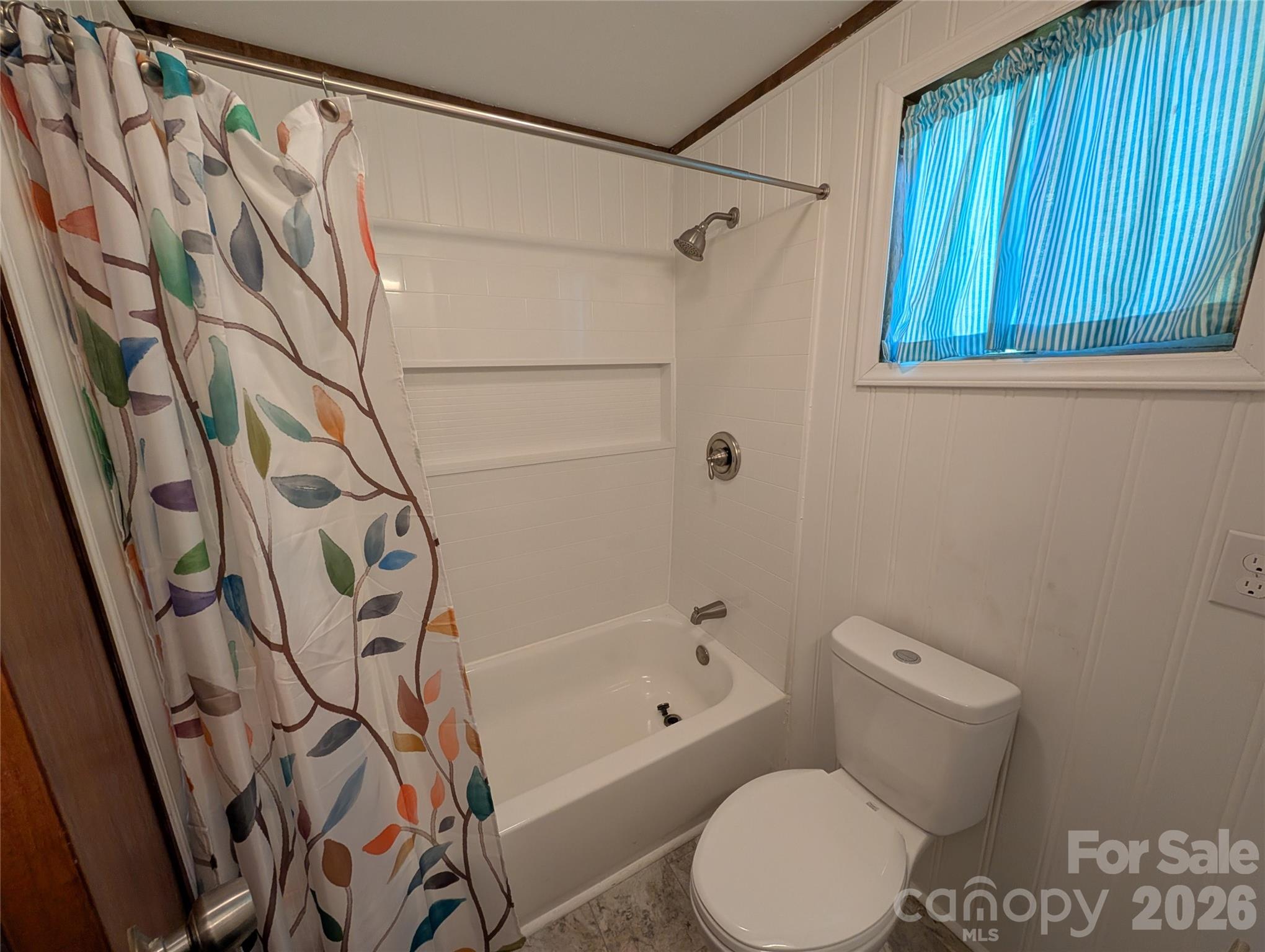 260 Oak Ridge Road Hendersonville, NC 28792 - Photo 18 of 24 a white toilet sitting next to a bath tub and shower