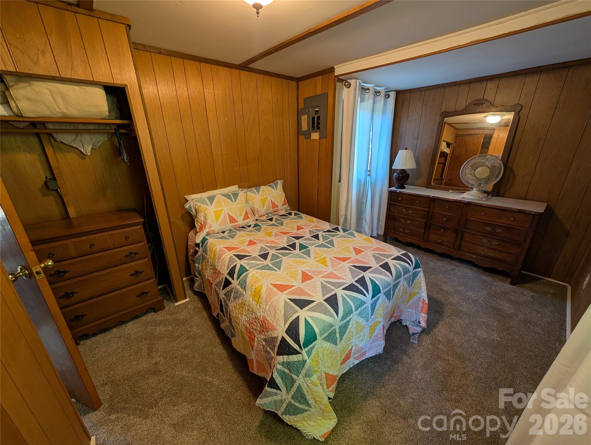 260 Oak Ridge Road Hendersonville, NC 28792 - Photo 21 of 24 a bedroom with a bed and a mirror on dresser