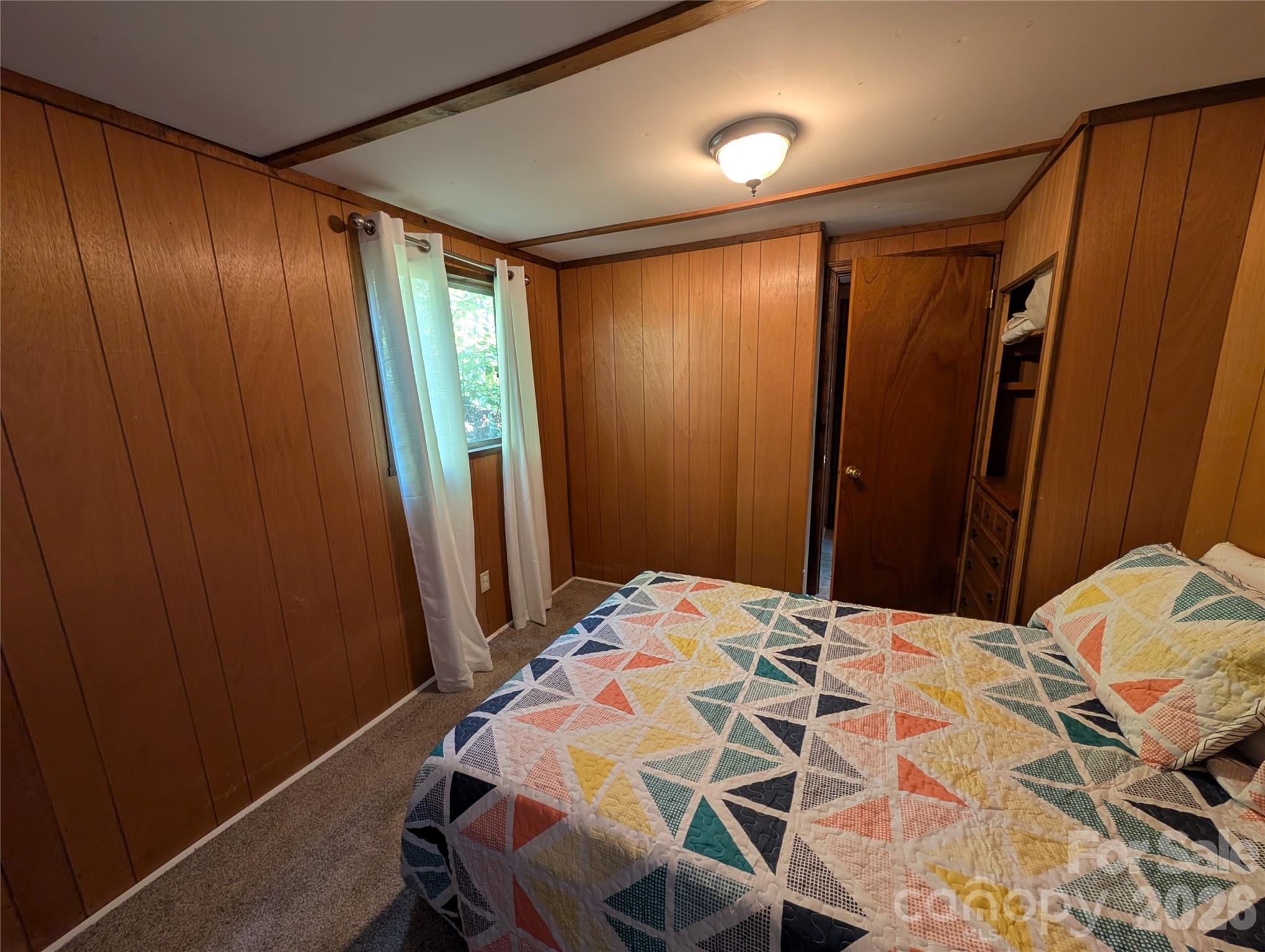 260 Oak Ridge Road Hendersonville, NC 28792 - Photo 22 of 24 a bedroom with a bed and a mirror