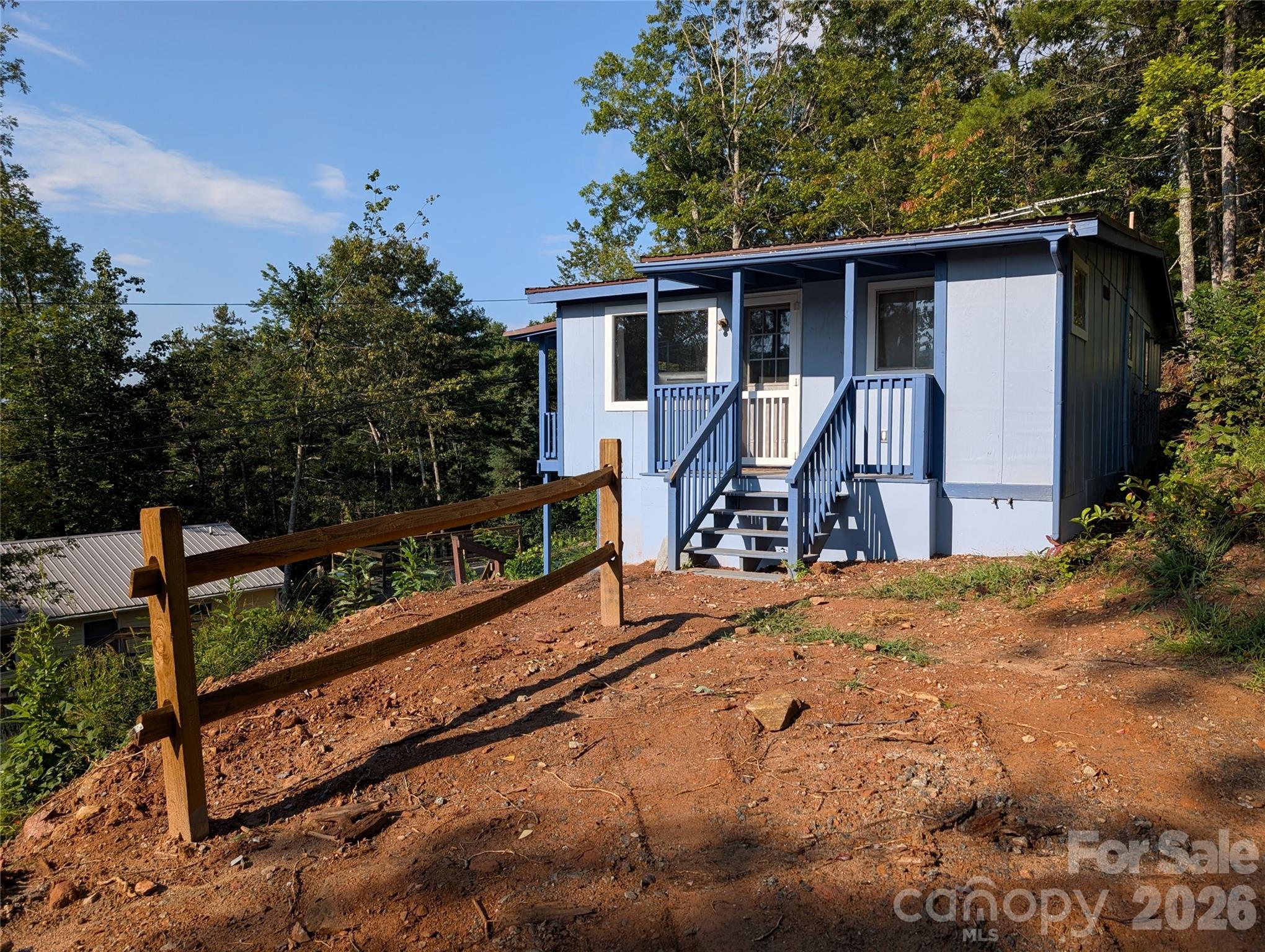 260 Oak Ridge Road Hendersonville, NC 28792 - Photo 6 of 24 a wooden bench sitting in front of a house