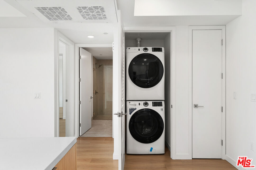 4406 Fulton Avenue, Unit 404 Sherman Oaks, CA 91423 - Photo 14 of 30 a view of a hallway with washer and dryer