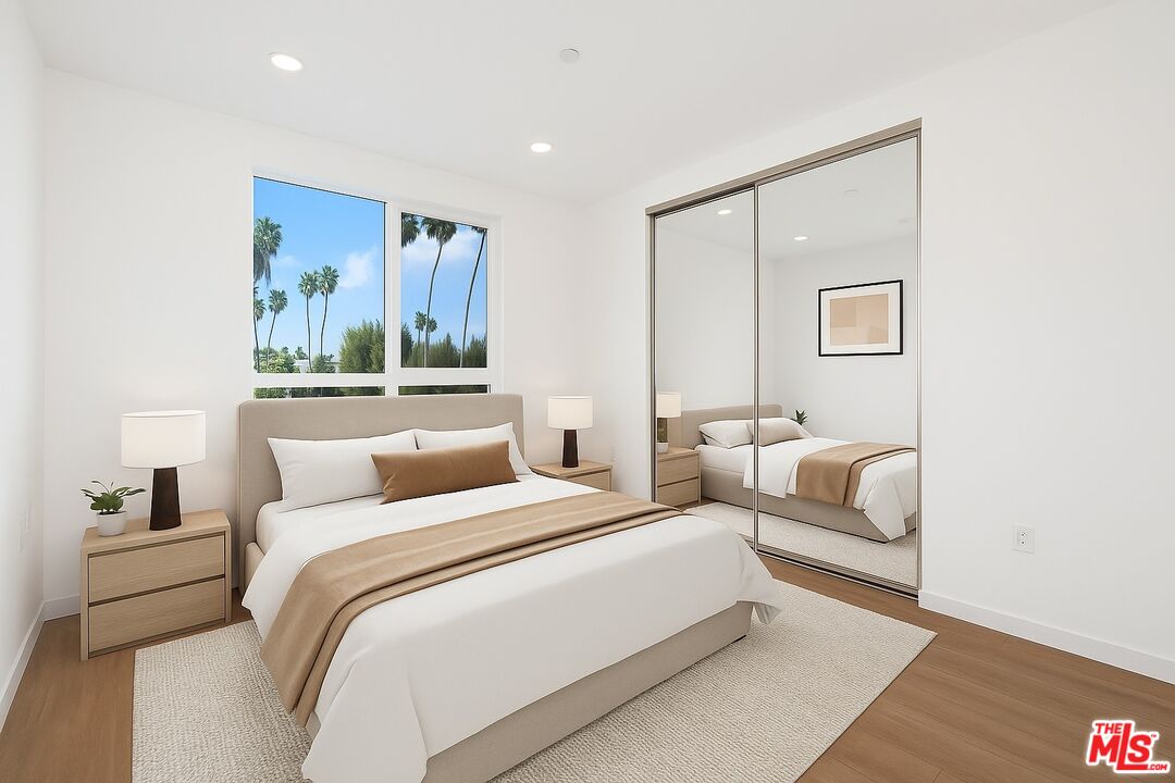 4406 Fulton Avenue, Unit 404 Sherman Oaks, CA 91423 - Photo 16 of 30 a bedroom with a large bed and a couch