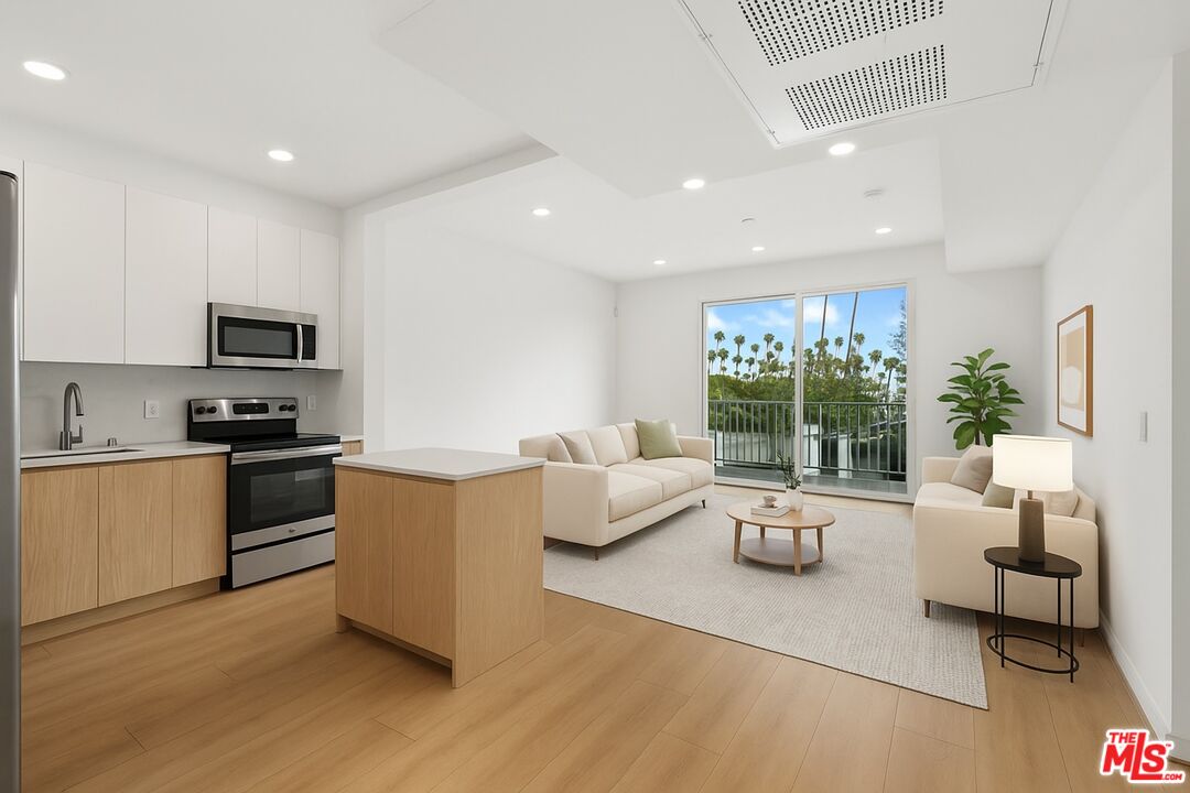 4406 Fulton Avenue, Unit 404 Sherman Oaks, CA 91423 - Photo 5 of 30 a living room with furniture and a large window
