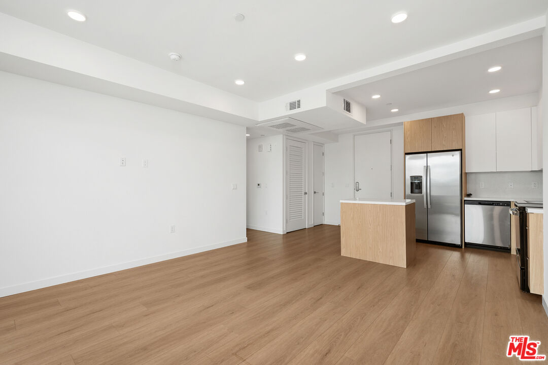 4406 Fulton Avenue, Unit 404 Sherman Oaks, CA 91423 - Photo 9 of 30 wooden floor in kitchen and a room with wooden floor and windows