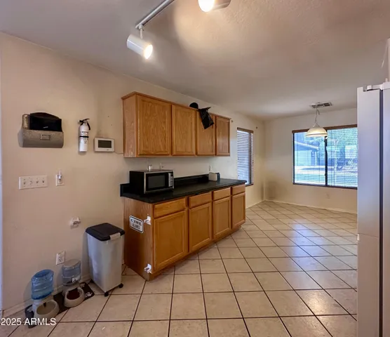 a kitchen with stainless steel appliances granite countertop a sink a stove a microwave a counter top space and cabinets