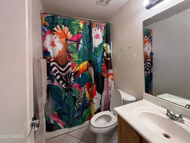 a bathroom with a sink mirror and toilet