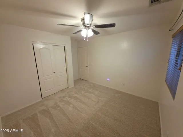 en empty room with fan and window