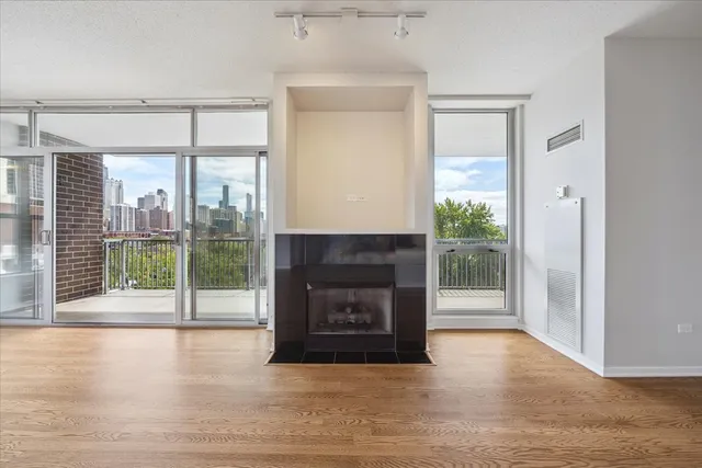 a living room with a fireplace and a floor to ceiling window