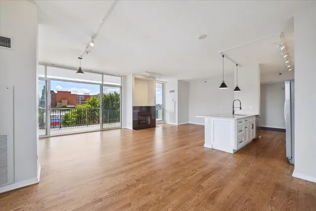 a view of a kitchen with furniture and wooden floor