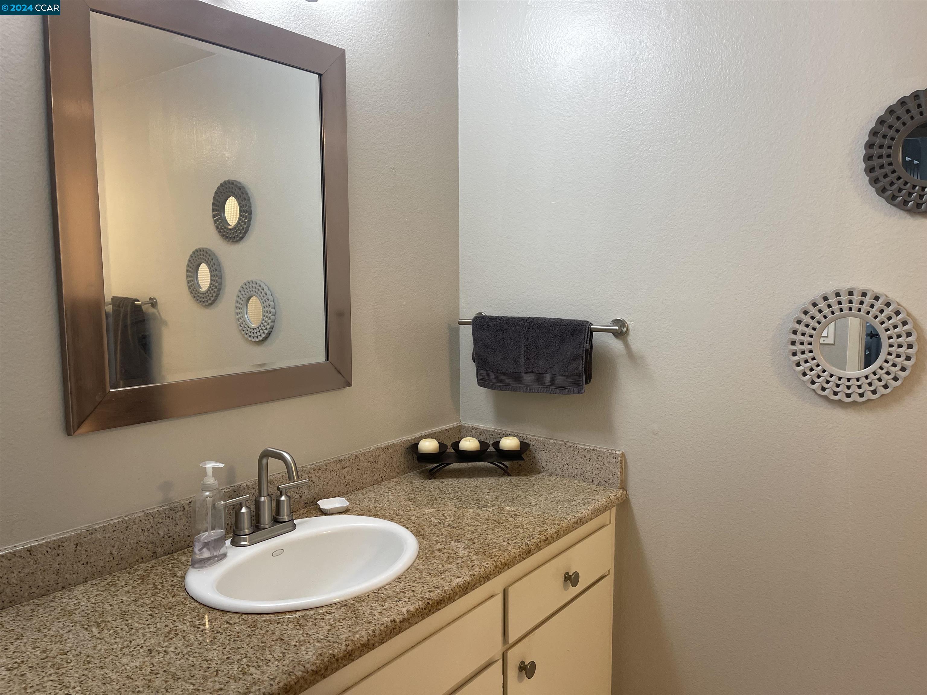 1900 St George Road Danville, CA 94526 - Photo 11 of 12 a bathroom with a granite countertop sink and a mirror