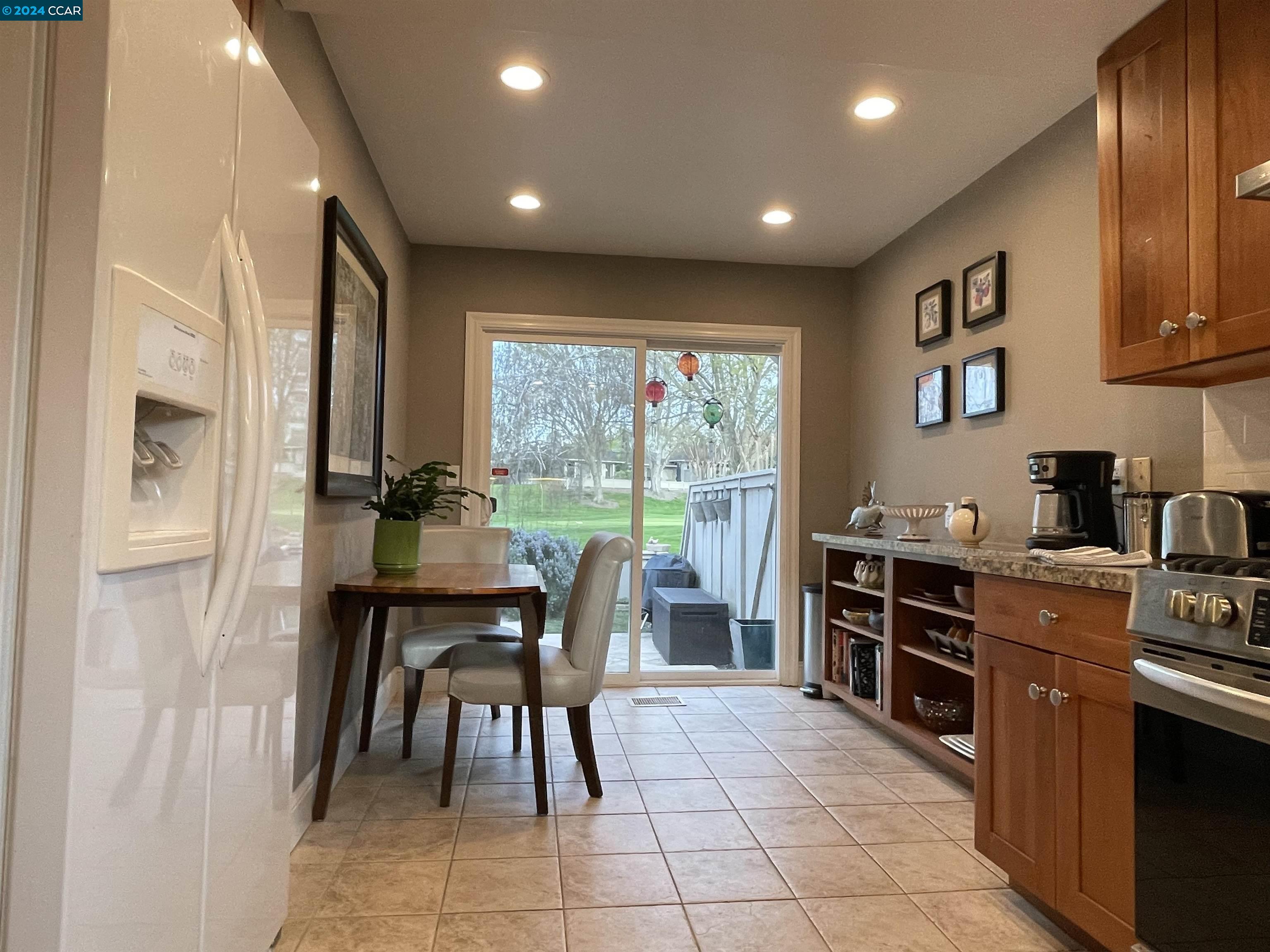 1900 St George Road Danville, CA 94526 - Photo 6 of 12 a kitchen with stainless steel appliances granite countertop table chairs sink and cabinets