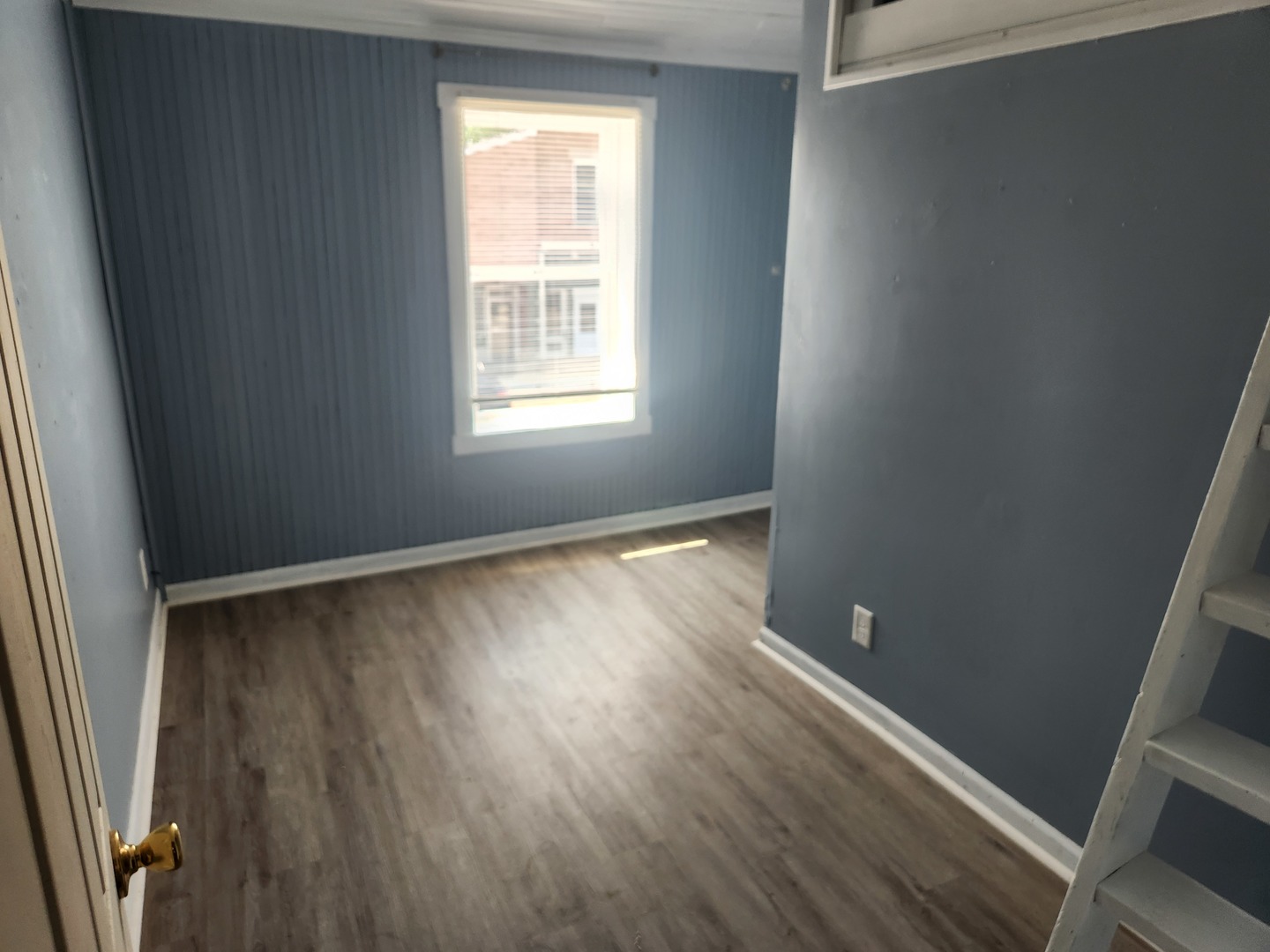 106 West Comanche Avenue, Unit 2W Shabbona, IL 60550 - Photo 10 of 11 an empty room with wooden floor and windows