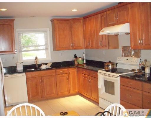 128 Drake Road Somerset, NJ 08873 - Photo 2 of 10 a kitchen with stainless steel appliances granite countertop a sink a stove a refrigerator cabinets and a window