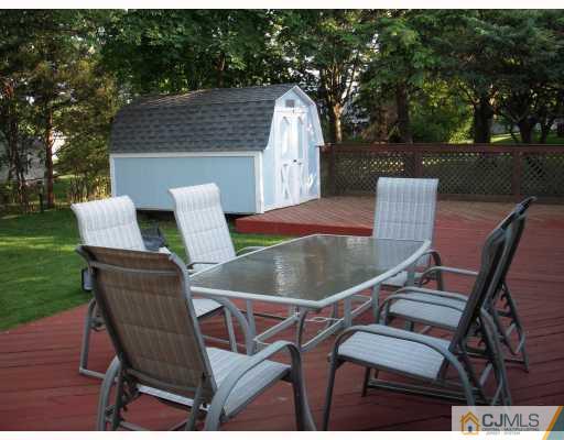 128 Drake Road Somerset, NJ 08873 - Photo 4 of 10 a view of a chairs and table in backyard