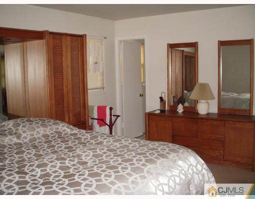 128 Drake Road Somerset, NJ 08873 - Photo 9 of 10 a bedroom with a bed and a dresser