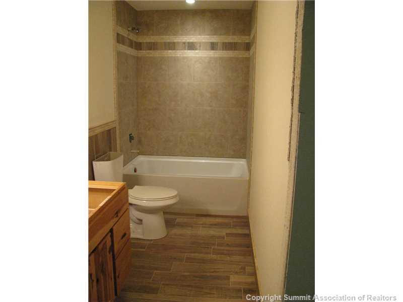 1135 Sheep Ridge Road Fairplay, CO 80440 - Photo 14 of 17 a bathroom with a granite countertop bathtub shower sink mirror and toilet