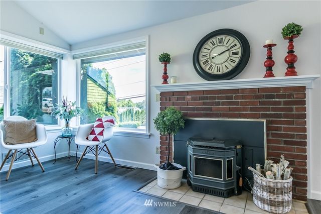a living room with furniture a window and a fireplace