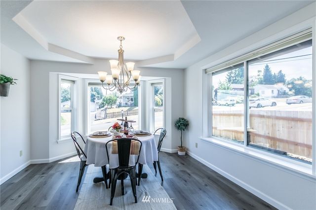 a view of a dining room with furniture window and outside view