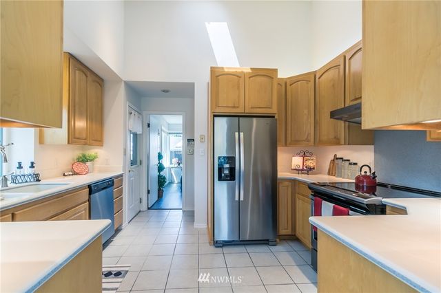 a kitchen with refrigerator cabinets and wooden floor