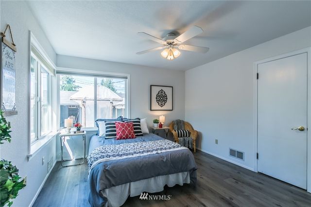 a bedroom with a large bed and a window
