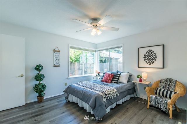 a bedroom with a large bed and a chandelier