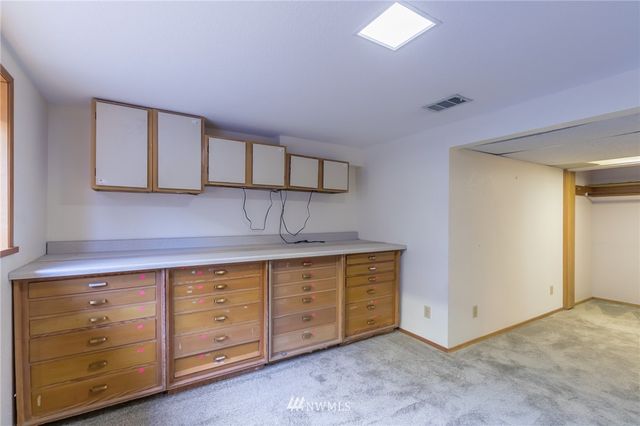 a view of backyard with wooden deck and seating space