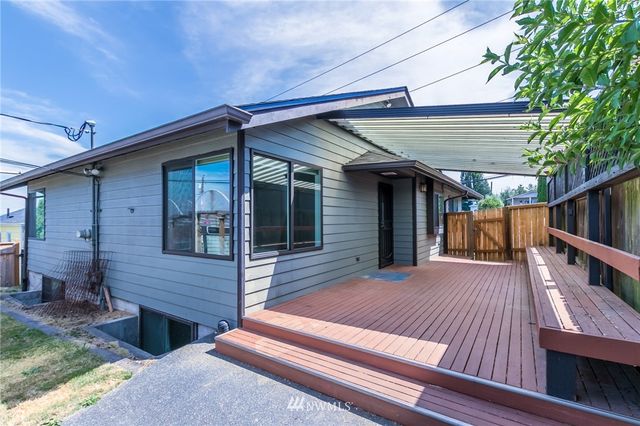 a view of a house with backyard porch and sitting area