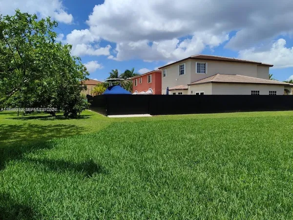 a front view of house with yard and trees