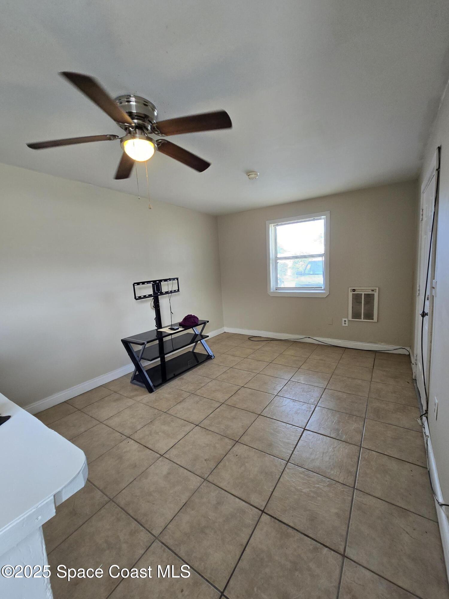 2320 Shenandoah Road, Unit A Palm Bay, FL 32905 - Photo 8 of 11 a living room with a window