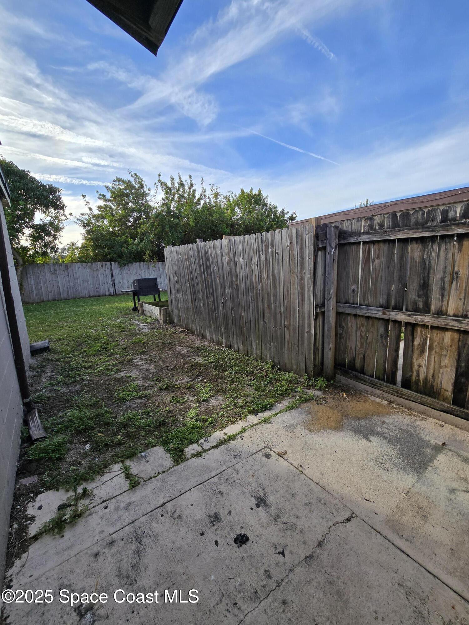 2320 Shenandoah Road, Unit A Palm Bay, FL 32905 - Photo 10 of 11 a view of a backyard with wooden fence