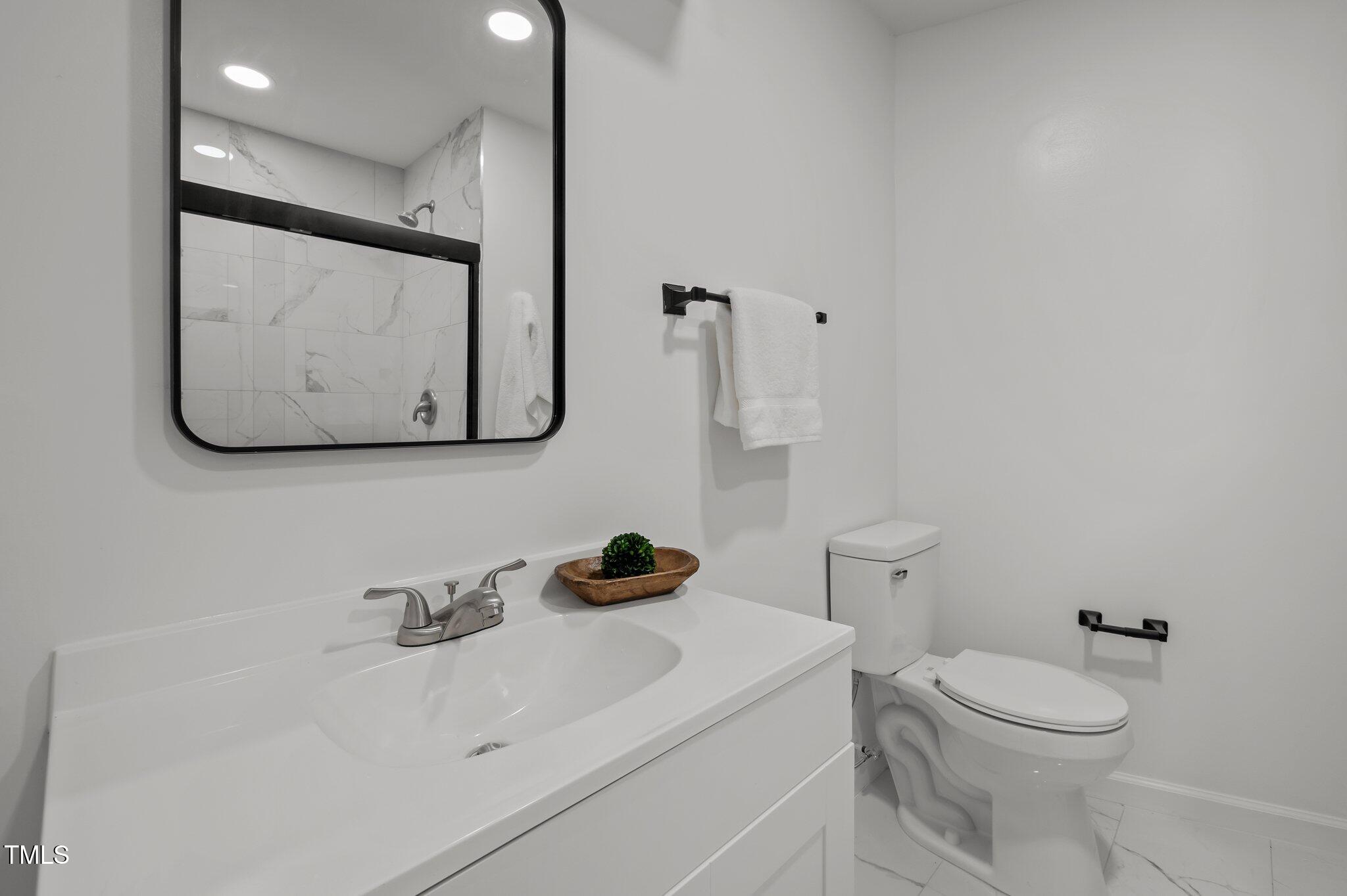 419 Obie Drive Durham, NC 27713 - Photo 19 of 33 a bathroom with a toilet sink and mirror