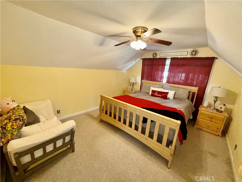 9312 Mountain Meadow Road Shingletown, CA 96088 - Photo 11 of 44 a bed room with a bed and a couch