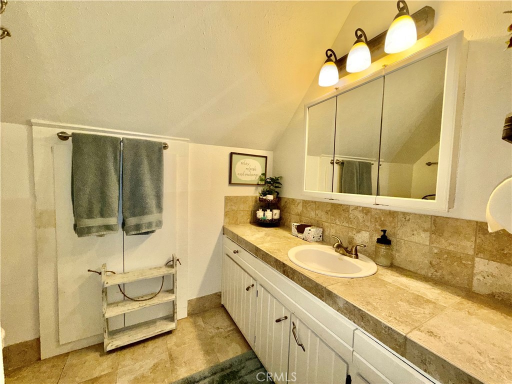 9312 Mountain Meadow Road Shingletown, CA 96088 - Photo 13 of 44 a spacious bathroom with a double vanity sink a mirror and a shower