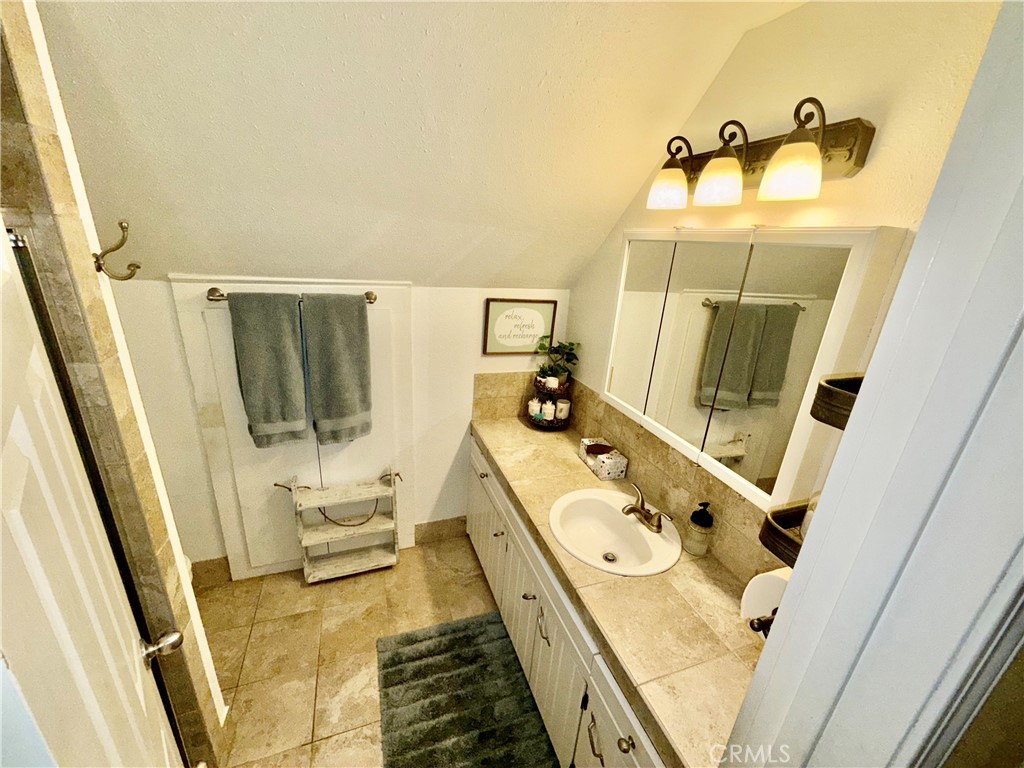 9312 Mountain Meadow Road Shingletown, CA 96088 - Photo 14 of 44 a bathroom with a tub sink and mirror
